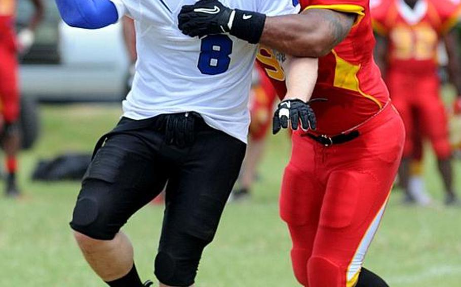 Kadena Dragons quarterback Jason Young tries to unload the football as Foster Bulldogs defender Kenneth Bryant gets a handful of Young's jersey during Saturday's U.S. Forces Japan-American Football League South Division game at Camp Foster, Okinawa. Foster won 30-14 and took a 11/2-game lead in the division over Kadena and Joint Task Force, each 0-1.