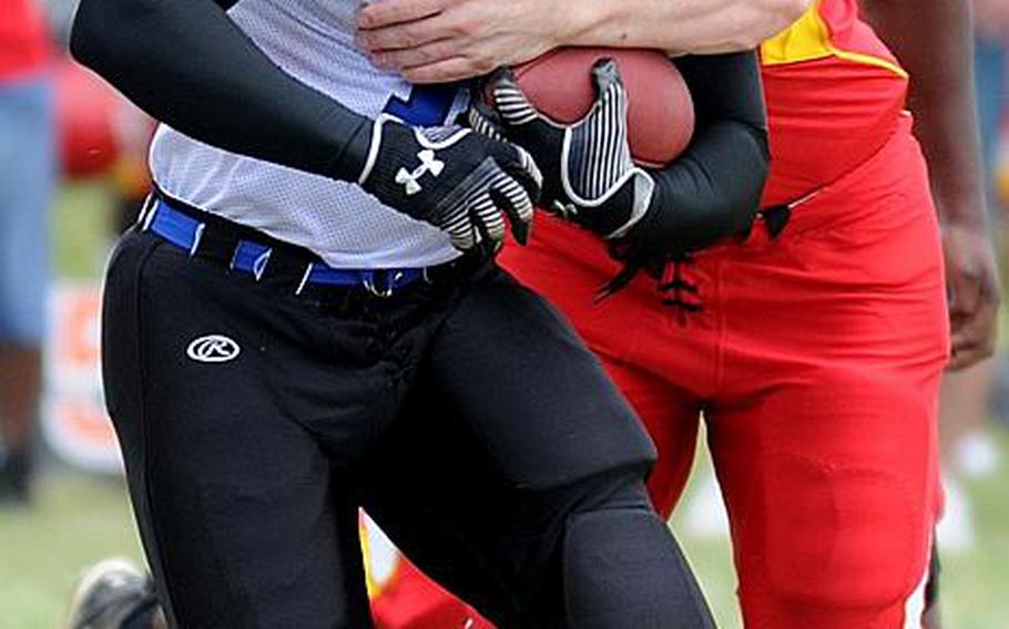 Kadena Dragons running back Terrence Nash gets wrapped up by Foster Bulldogs defender Will Good during Saturday's U.S. Forces Japan-American Football League South Division game at Camp Foster, Okinawa. Foster won 30-14 and took a 11/2-game lead in the division over Kadena and Joint Task Force, each 0-1.