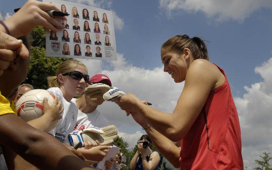 Hope Solo, the U.S. Women's National Team goal keeper, signs autographs after Thursday's practice session held at SG Kirchheim soccer field in Heidelberg, Germany, before the team's second 2011 World Cup game against Colombia. Many local U.S. military members and their families were invited to watch the practice session.
