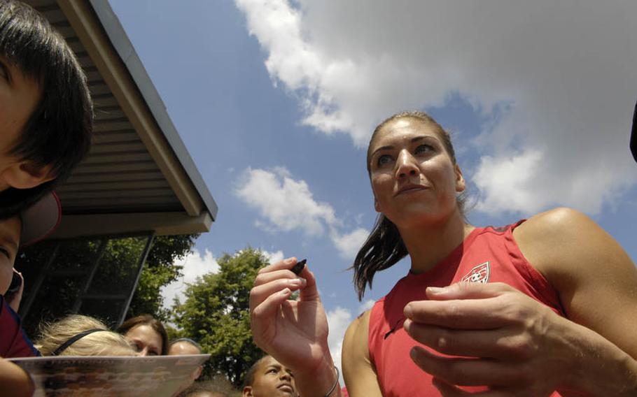 Hope Solo, the U.S. Women's National Team goalkeeper, signs autographs after Thursday's practice session at SG Kirchheim soccer field in Heidelberg, Germany, before the team's second 2011 World Cup game against Colombia. Many local U.S. military members and their families were invited to watch the practice session.