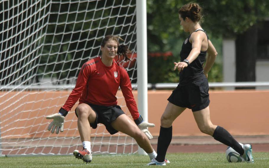 Kelley O'Hara, right, tries to slice the ball past teammate Hope Solo during a U.S. women's national soccer team practice Thursday in Heidelberg. Hundreds of members of  American military communities came out to watch the team. The WNT plays their second game of the World Cup against Colombia on Saturday in Sinsheim.