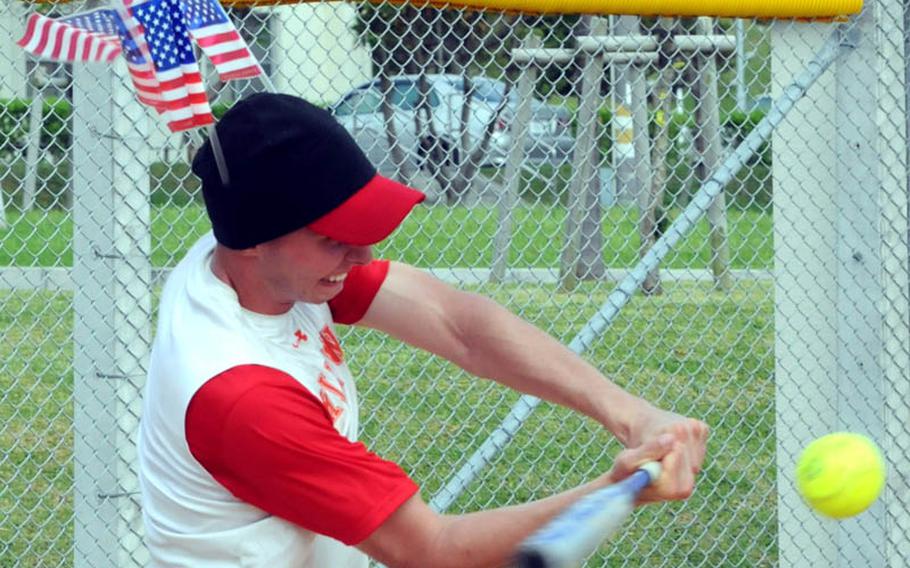 Sporting headgear with three American flags in honor of Independence Day, left-fielder David Casetta of Transportation Management Office Raw Dogs of Camp Foster, Okinawa, belts a three-run double against Misawa Air Base, Japan, during Saturday's pool-play game in the 2011 Firecracker Shootout Pacificwide interservice softball tournament at Camp Foster, Okinawa. Misawa beat Raw Dogs, 13-3.