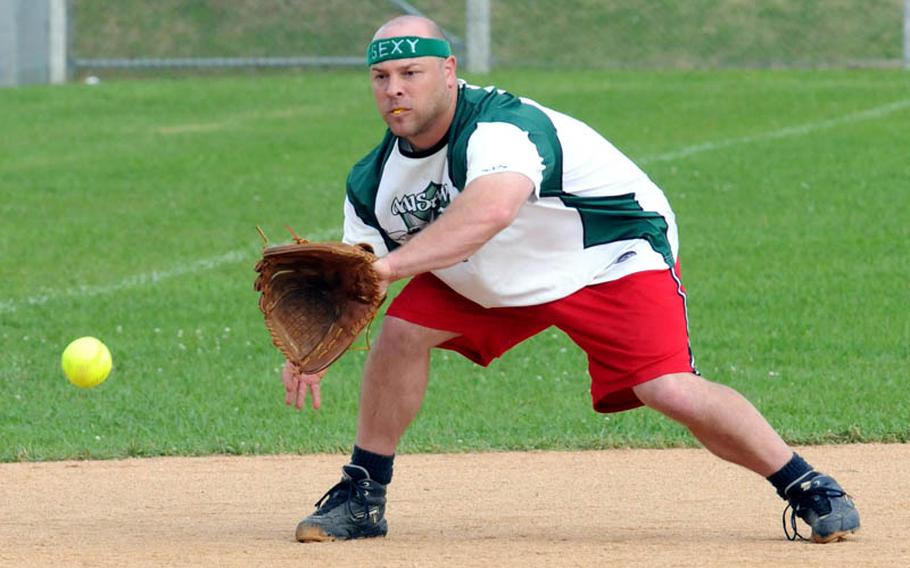 Misawa Air Base third baseman Josh Mueller fields a ground ball from Transportation Management Office Raw Dogs of Camp Foster, Okinawa, during Saturday's pool-play game in the 2011 Firecracker Shootout Pacificwide interservice softball tournament at Camp Foster, Okinawa. Misawa beat Raw Dogs, 13-3.