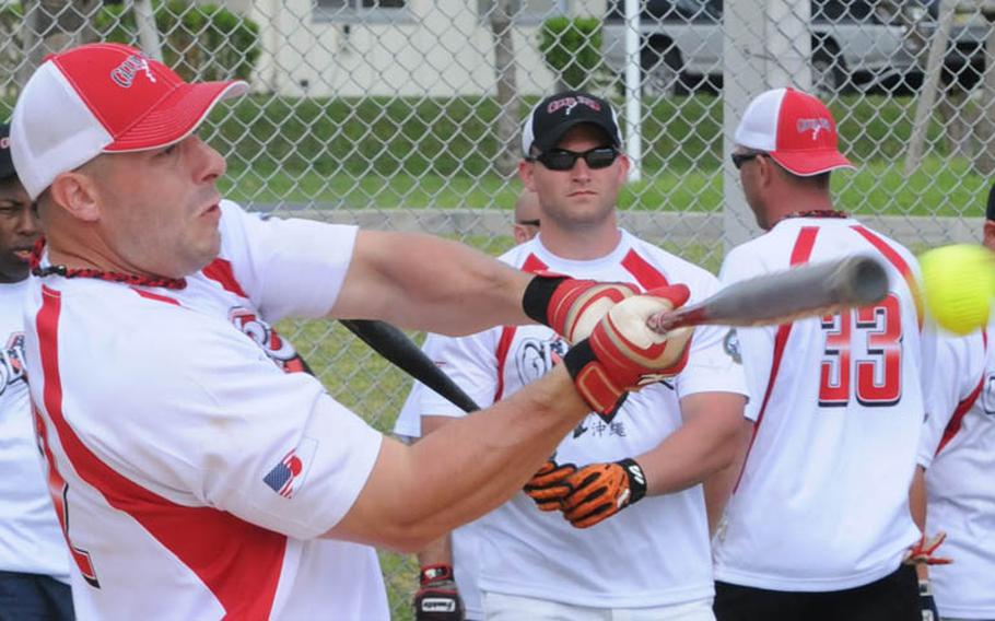Steven Jurgensen of Club Red, Okinawa, belts a base hit against Hit Squad, Okinawa, during Saturday's pool-play game in the 2011 Firecracker Shootout Pacificwide interservice softball tournament at Camp Foster, Okinawa. Club Red silenced Hit Squad, 11-1.
