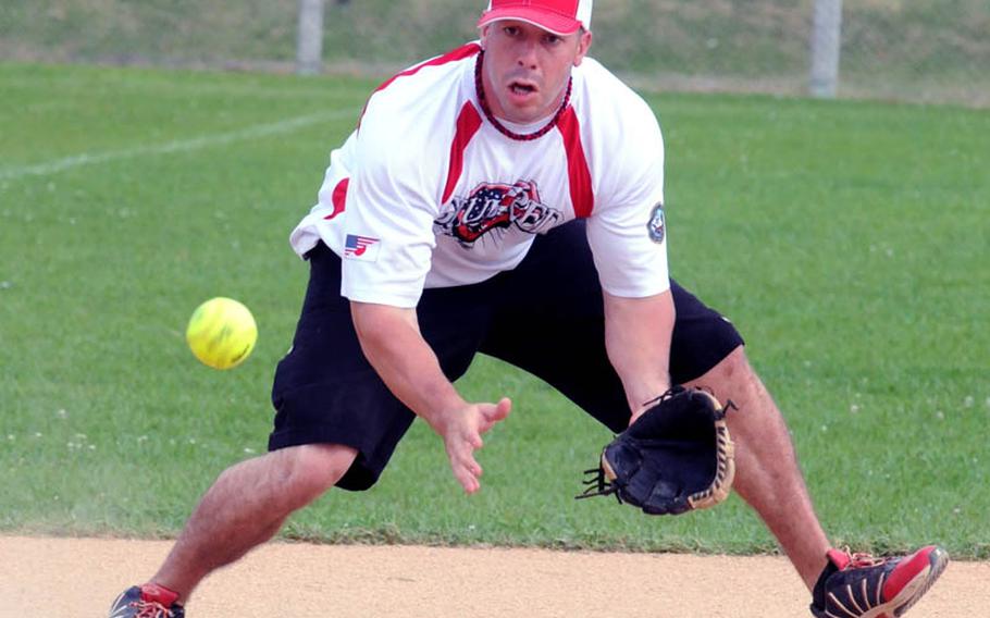Steven Jurgensen of Club Red, Okinawa, fields a ground ball against Hit Squad, Okinawa, during Saturday's pool-play game in the 2011 Firecracker Shootout Pacificwide interservice softball tournament at Camp Foster, Okinawa. Club Red silenced Hit Squad, 11-1.