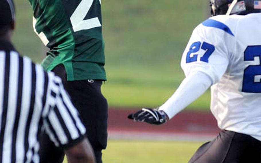 Joint Task Force Wolf Pack receiver Shelton Swopes snags a pass near the end zone pylon against Kadena Dragons defender Harold Mears during Saturday's U.S. Forces Japan-American Football League South Division game at Camp Foster, Okinawa. Kadena won 22-12 and leveled its record at 2-2, earning host rights to the July 30 first-round playoff game against JTF (0-3).