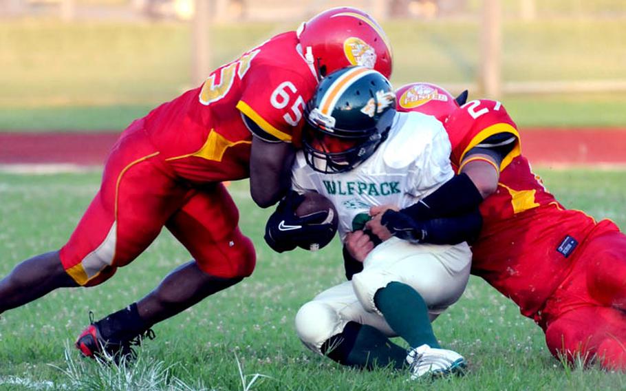 Joint Task Force Wolfpack running back Jorge delosRios gets tackled in the end zone for a safety by Foster Bulldogs defenders Anthony "Radio" Linzy, left, and Zack Zindler during Saturday's U.S. Forces Japan-American Football League South Division season finale at Camp Foster, Okinawa. Foster won 30-8 to complete a 4-0 regular season.