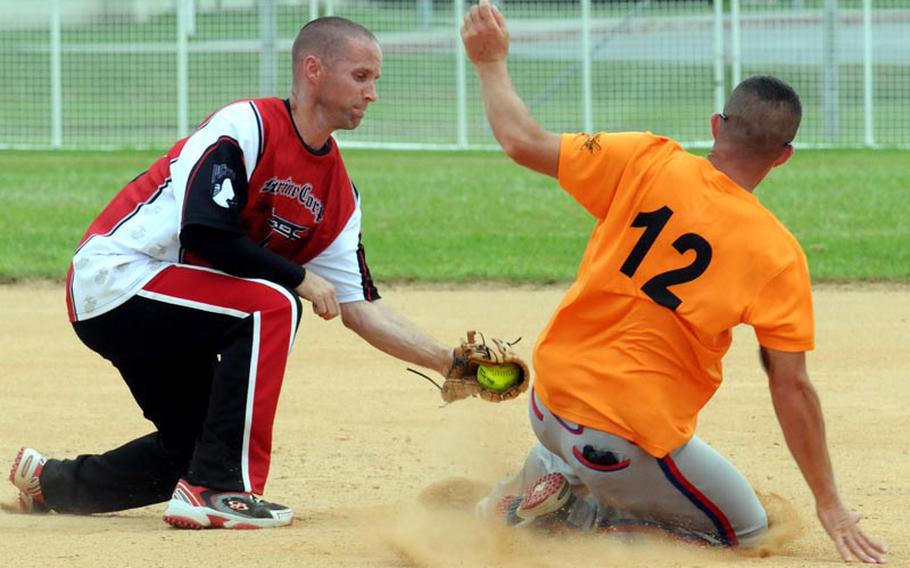 Marine Corps Base Camp S.D. Butler shortstop Thomas Meinhart applies the tag to 3rd Marine Logistics Group baserunner Daniel Polk during Friday&#39;s championship-bracket final game in the double-elimination playoffs in the 2011 Marine Corps Far East Regional Softball Tournament at Field 1, Gunners Fitness & Sports Complex, Camp Foster, Okinawa. Polk was ruled safe on the play. 3rd MLG won 7-6 in nine innings, then beat Base again 11-9 in Friday&#39; evening&#39;s championship game, winning the title for the second straight year.