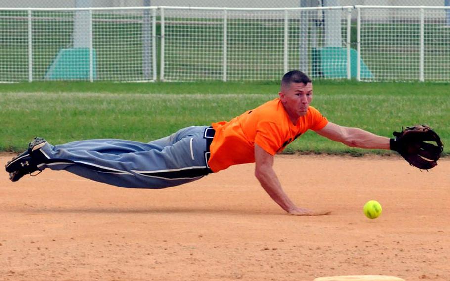 Shortstop and tournament Most Valuable Player Derrick Battle of 3rd Marine Logistics Group dives for a Marine Corps Base Camp S.D. Butler ground ball during Friday&#39;s championship-bracket final game in the double-elimination playoffs in the 2011 Marine Corps Far East Regional Softball Tournament at Field 1, Gunners Fitness & Sports Complex, Camp Foster, Okinawa. 3rd MLG won 7-6 in nine innings, then beat Base again 11-9 in Friday&#39; evening&#39;s championship game, winning the title for the second straight year.