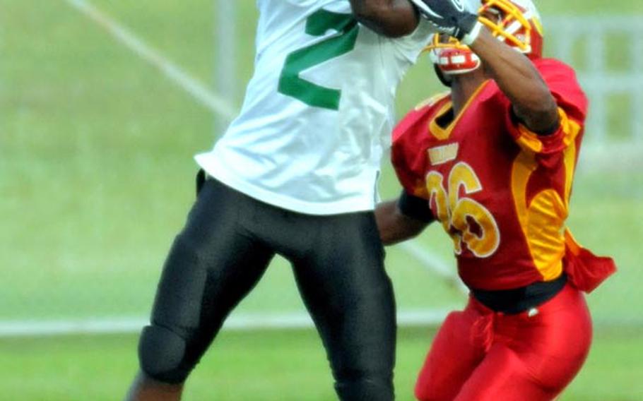 Joint Task Force Wolfpack receiver Trinadai Stansel (2) comes down with a touchdown pass against Foster Bulldogs defender Javir Davis (26) during Saturday's U.S. Forces Japan-American Football League South Division title game.