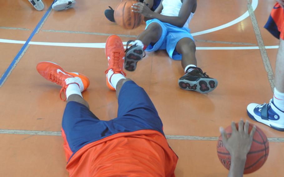 Illinois players and Aviano kids show off their dribbling skills during a clinic Wednesday on base put on by players and coaches from the universities of Illinois and West Virginia.