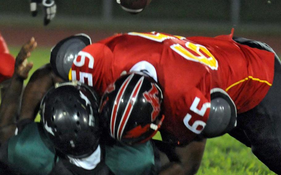 The football squirts loose as Foster Bulldogs defender Anthony "Radio" Linzy sacks Misawa Jets quarterback Douglas Brown during Saturday's Torii Bowl league title game at Misawa Air Base, Japan. The Bulldogs rallied from a 20-2 deficit to beat the Misawa Jets 24-20, the first road victory in Torii Bowl history and the second USFJ-AFL title for Foster in three seasons.