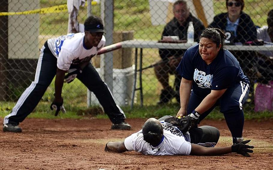 Toria Leon, Lakenheath's catcher, tags Erica Calgero, of Ramstein, out at home in the U.S. Forces Europe women's softball championships Sunday at Spangdahlem Air Base in Germany. Ramstein won the title.