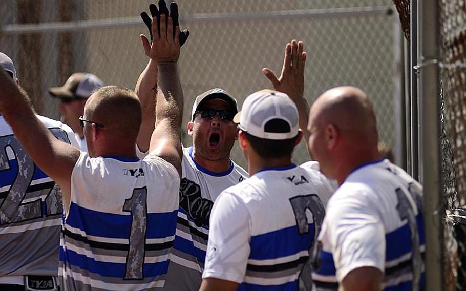 Ramstein's men's softball team celebrates after Mark Noll, center, hit a home run during the U.S. Forces Europe softball championships at Spangdahlem Air Base.