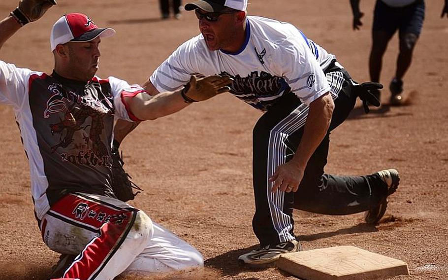 Ramstein's third baseman Mark Noll tags out Aviano's left fielder Jason Paminski in the U.S. Forces Europe softball championships Sunday at Spangdahlem Air Base, Germany. The Rams won the title.