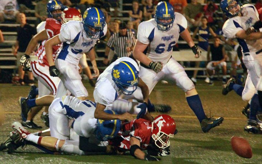 Yokota Panthers defenders chase down a fumble by Nile C. Kinnick Red Devils running back Dustin Kimbrell during Friday's DODDS-Japan/Kanto Plain high school football game at Yokosuka Naval Base, Japan. Yokota blanked Kinnick 34-0.