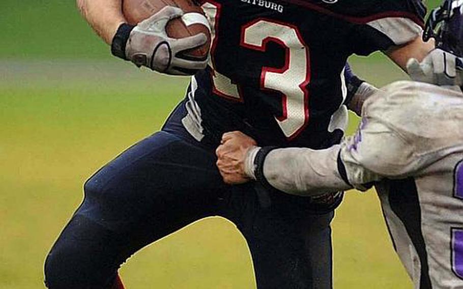Bitburg's Kyle Edgar keeps a Mannheim player at arms length as he picks up yardage in last season's championship game.