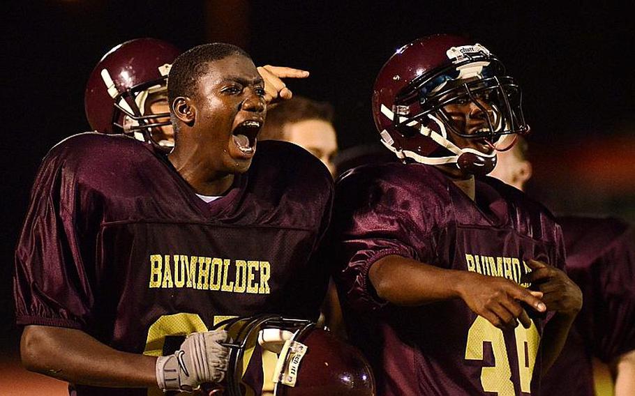 Dasante Browne, left, and Kamryn Wilson, of Baumholder react after a teammate scored a touchdown Friday night at  Baumholder, Germany.