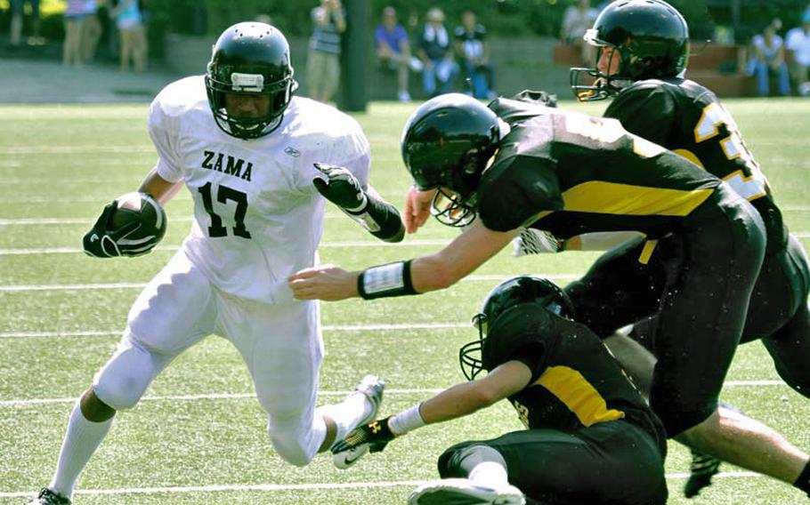 Zama American Trojans running back Mitchell Harrison tries to elude three American School In Japan defenders during Saturday's Kanto Plain Association of Secondary Schools football game in Tokyo. ASIJ rallied from a 20-14 deficit to beat the Trojans 42-26.