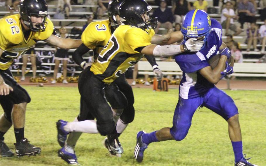 American School In Japan Mustangs kick coverage man Haru Kent gets a handful of Yokota Panthers returner Morgan Breazell's facemask as ASIJs Tyler Noyes and Ken Yajima give chase during Friday's Kanto Plain Association of Secondary Schools football game at Yokota High School,  Japan. Yokota won 41-20.