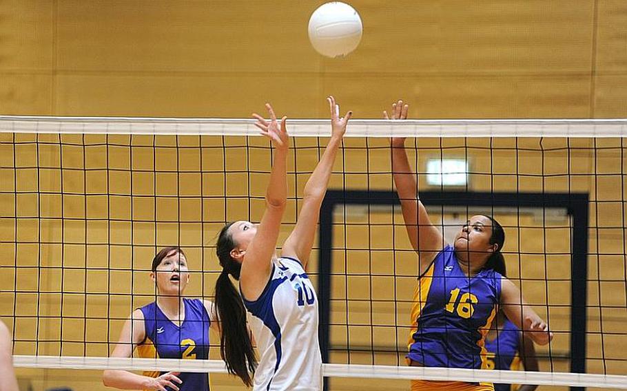 Wiesbaden's Andrea Arnold, center, and Schweinfurt's Chealsea Sias battle at the net as Brigitte Keene watches at left. Wiesbaden won two games against Schweinfurt 25-13, 25-15, in a 35-minute match at a jamboree in Wiesbaden on Saturday. It was the first match for Schweinfurt, a new DODDS school.
