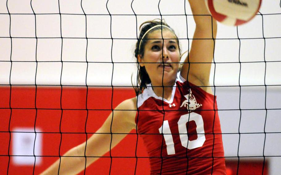 Nile C. Kinnick Red Devils senior middle blocker Emily Stith drives a spike kill against the Zama American Trojans during Saturday's DODDS Japan three-way series at Nile C. Kinnick High School, Japan. Kinnick won 25-9, 25-7, 25-15 to stretch its regular-season winning streak to 63 straight dating back to the start of the 2009 season.