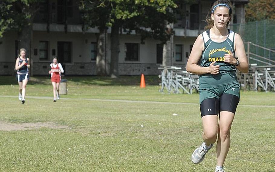 Alconbury senior Alex Sherenco tries to maintain a gap between her and two trailing runners during the cross country season opener Saturday at RAF Lakenheath,