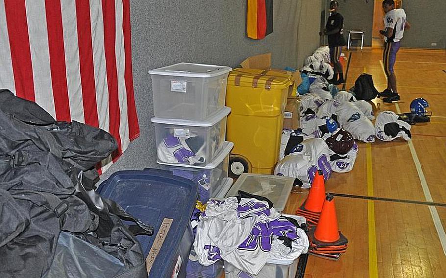 Donated equipment lies in piles in the Schweinfurt High School gym as the football team prepares for the first season at the new school.