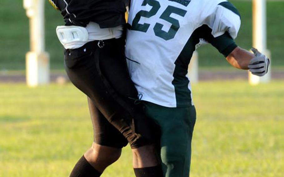 Kadena Panthers receiver Josh Dyer struggles to catch the ball against Kubasaki Dragons defender Jace Johnson during Friday's Okinawa Activities Council football game at Kadena High School. The pass fell incomplete. Kubasaki won 13-0.