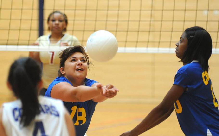 Ansbach's Alyssa Solis bumps the ball in front of teammates Princess Chia, left, and Chealsy Reaves. Division II Ansbach lost their match against defending D I champion Vilseck 18-25, 13-25, 18-25, in Wiesbaden on Saturday.