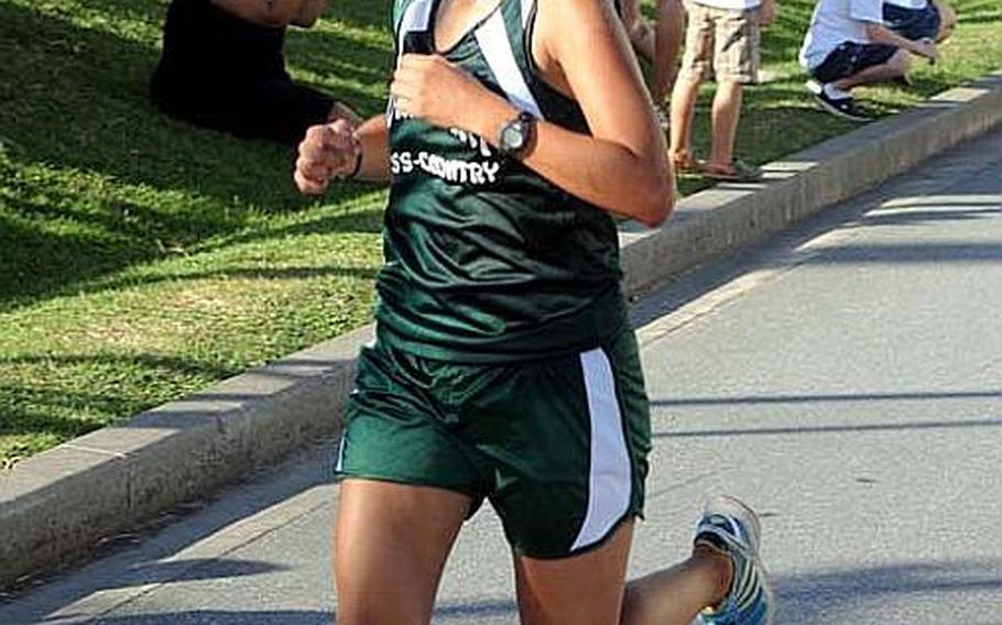 Kubasaki Dragons sophomore cross country runner Alle Robles pushes for the finish line during Wednesday's Okinawa Activities Council's fourth cross-country meet of the season at Camp Foster, Okinawa. Robles won 21 minutes, 29 seconds, her fastest time of the season.