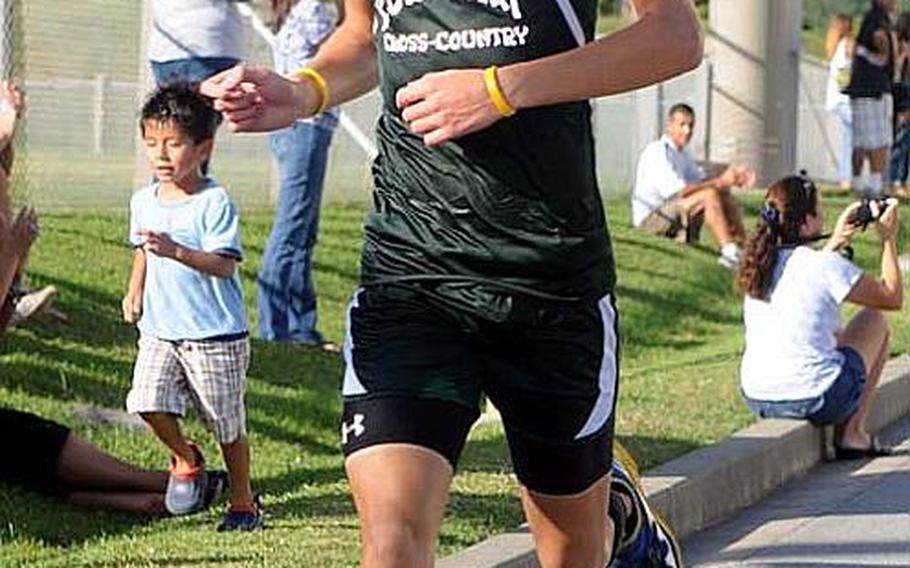 Kubasaki Dragons freshman cross-country runner Erik Armes pushes for the finish line during Wednesday's Okinawa Activities Council meet at Camp Foster, Okinawa. Armes won in 17 minutes, 22 seconds, his fastest time of the season.