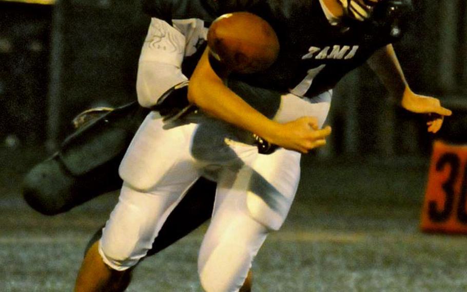 Zama American Trojans quarterback James Liker has the ball knocked out of his hands by Robert D. Edgren Eagles defender Louis Murphy during Friday's DODDS Japan and Far East Division II qualifying game at Yokosuka Naval Base, Japan. Zama won 41-7, qualifying for its third straight Far East D-II football title game Nov. 5 in Korea.