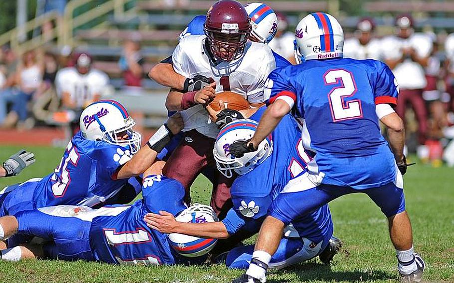 A pride of Ramstein Royals drag down Vilseck's Daniel Arroyo after the Falcon running back picked up yardage. The Ramstein defense shut out the Falcons for a 28-0 homecoming win on Saturday.