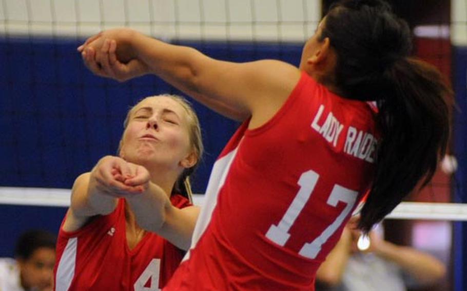 Kaiserslautern's Tonje Lunde, left, and Sharisse Malay return a Ramstein shot in the Lady Raiders' 25-5, 25-14, 25-15 loss to the Royals in Ramstein on Saturday.