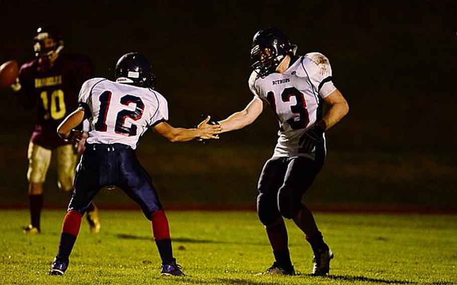 Kyle Edgar celebrates with Corey Bashon after scoring a touchdown Friday night in the Bitburg Barons' 40-14 win against the Baumholder Buccaneers.