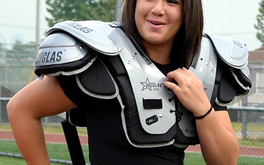 Daegu American Warriors sophomore kicker Haley Claiborne straps on her shoulder pads.