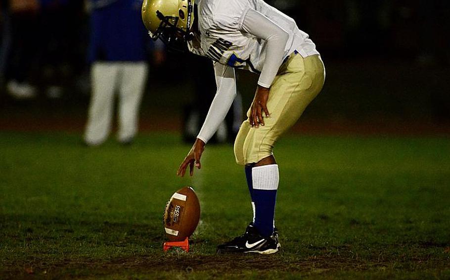 Wiesbaden's kicker, Dennis Ringgold, places the football on his tee before a kickoff Friday night.