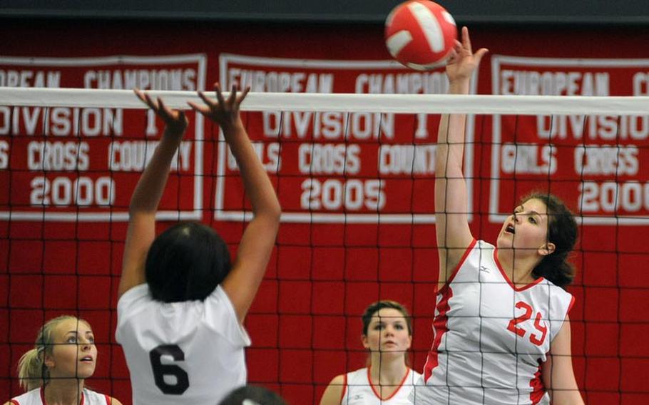 Kaiserslautern's Kalynn Richardson, right, knocks the ball over the net against the defense of Baumholder's Joanna Oviedo. Kaiserslautern beat Baumholder 25-18, 20-25, 25-11, 25-21 at home on Saturday. Watching the action at left is Tonje Lunde and Alexis Berg at center.