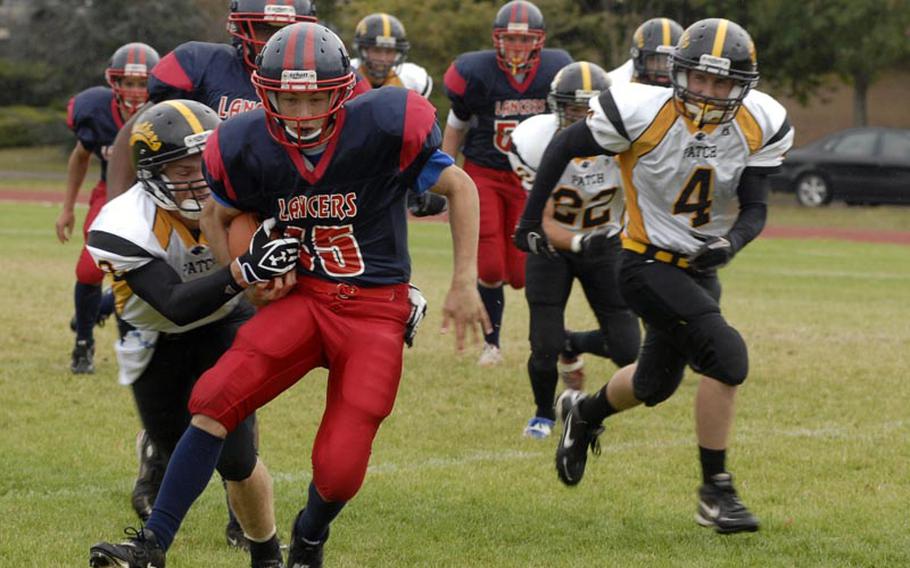 Lakenheath tailback Austin Morrow tries to evade Panther defender Sean Rittenhouse, with Patch?s Jaden Wilsted in pursuit. The Lancers lost the contest 21-0 - marking the second time this season Lakenheath has been held scoreless while playing at home.