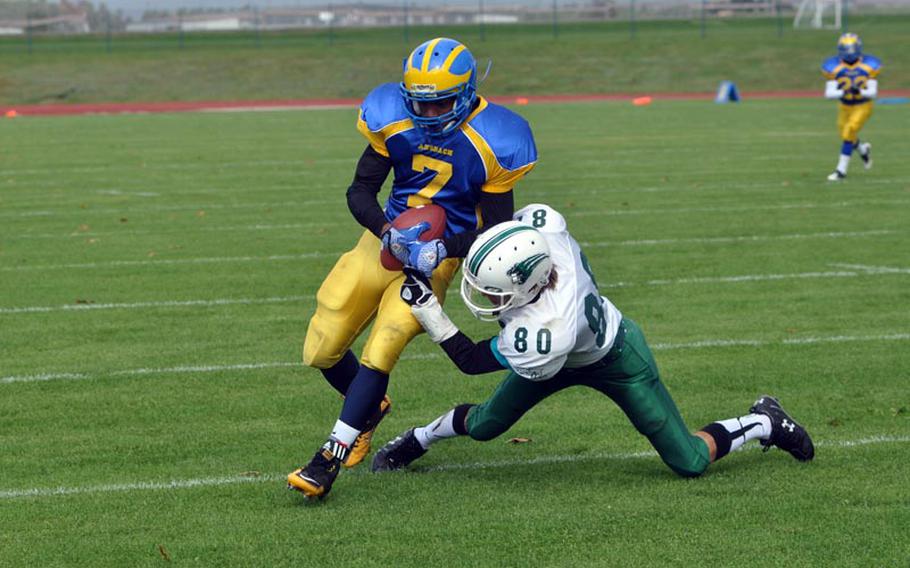 Naples defender Jordon Gonzales tries to bring down Derrick Flake Saturday in the Wildcats' 41-40 comeback win over the Cougars.