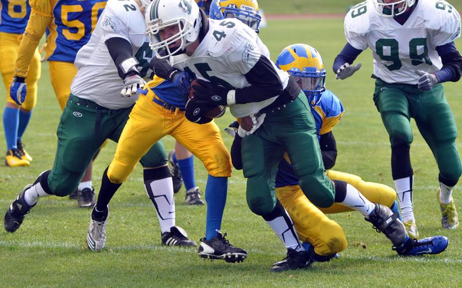 Naples senior Sam LeVault tries to break free from the Ansbach defense Saturday in the Wildcats' 41-40 comeback win over the Cougars. LeVault rushed 38 times for 163 yards and a touchdown for visiting Naples.