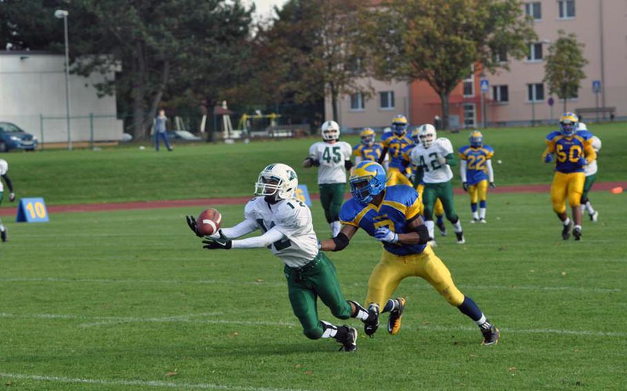 Naples defensive back JunJun Gallardo dives for an interception on the last play of a 41-40 victory for the visiting Wildcats Saturday in Ansbach.