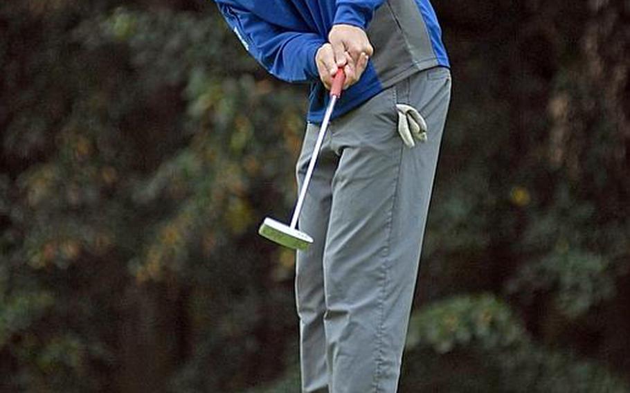 Ramstein senior James Cho watches his ball roll towards the hole during last week's high school golf tournament in Wiesbaden, Germany.