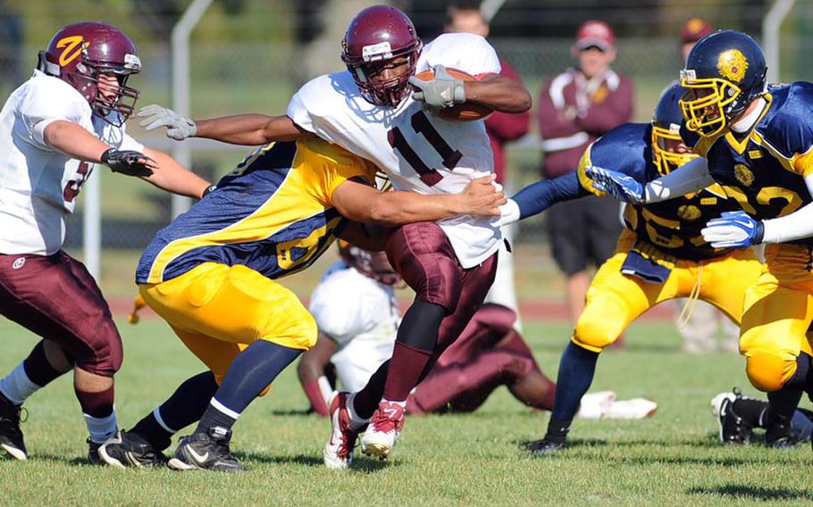 Vilseck's Carlton Campbell escapes a group of Heidelberg Lions for a gain, but the Lions won the Division I game 15-14.