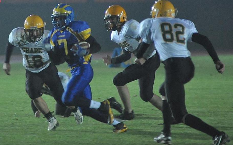 Ansbach senior Derrick Flake breaks free from the SHAPE defense Friday night in Ansbach. Ansbach won the game 66-13.
