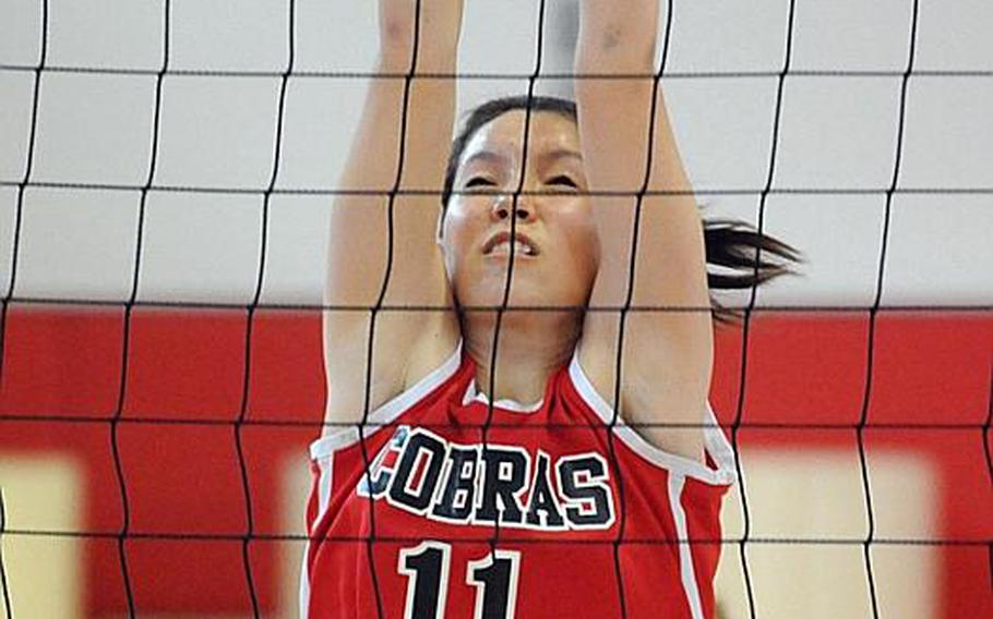 E.J. King Cobras senior outside hitter Sarah Fitzwater blocks a Yokota Panthers shot during Saturday's semifinal match in the 2011 DODDS Japan Girls Volleyball Tournament at Nile C. Kinnick High School, Japan. The Cobras won 25-13, 25-17, 25-13, but lost in the championship to Nile C. Kinnick 24-26, 25-16, 25-13, 25-9.