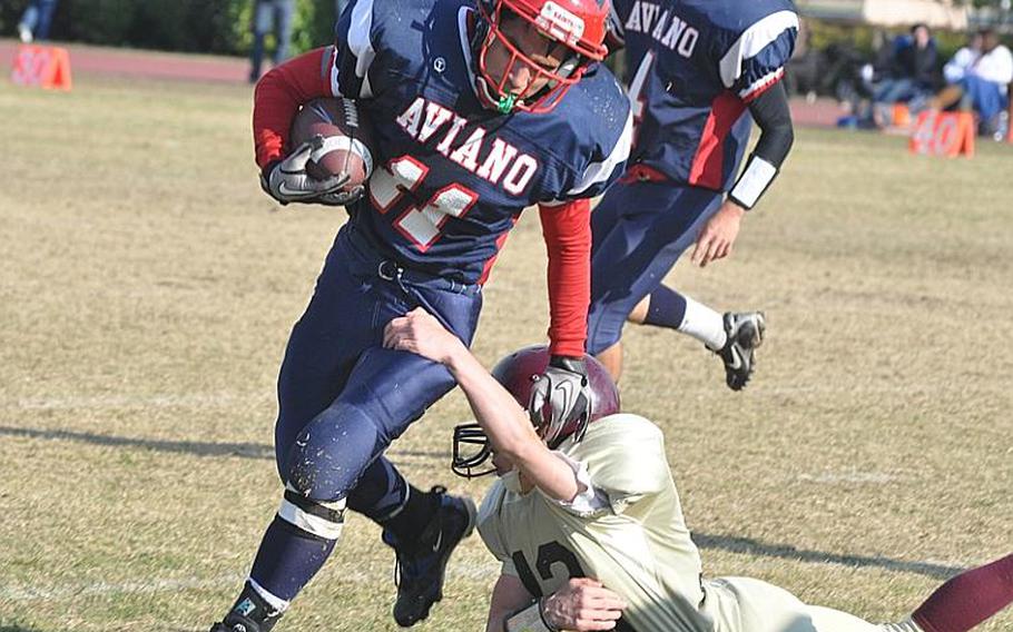 Aviano's Nik Weiser breaks away from Baumholder's Blake Brittain during a 15-yard gain in the fourth quarter Saturday in the Saints' 48-24 victory over the Bucs.