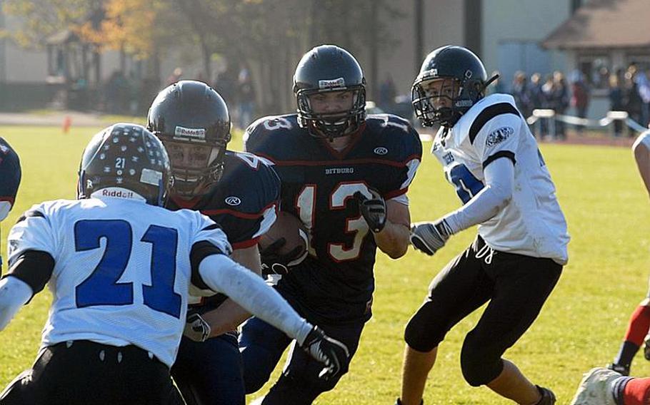 Bitburg All-Europe running back Kyle Edgar finds a hole en route to a second half touchdown during Saturday's playoff victory over the Tigers.