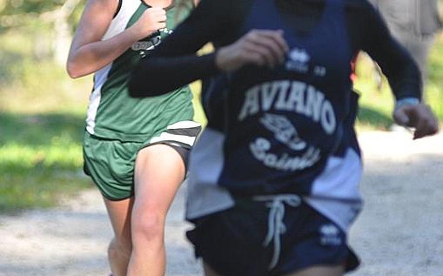 Aviano's Shelby McHugh edges Naples' Alexis Cutler in one of the closest finishes of the day in a dual meet between the two schools at Parco San Floriano near Polcenigo, Italy. McHugh was fifth in 23 minutes, 9 seconds, with Cutler just two seconds behind.